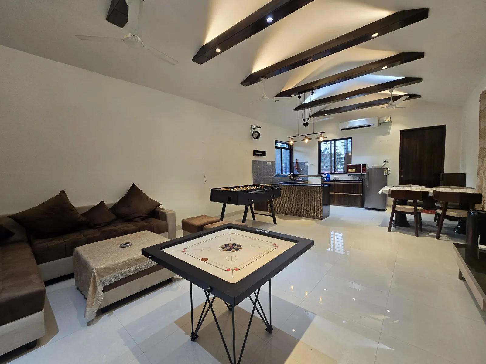 Games hall with a sofa, carrom and foosball at Gokul Villa
