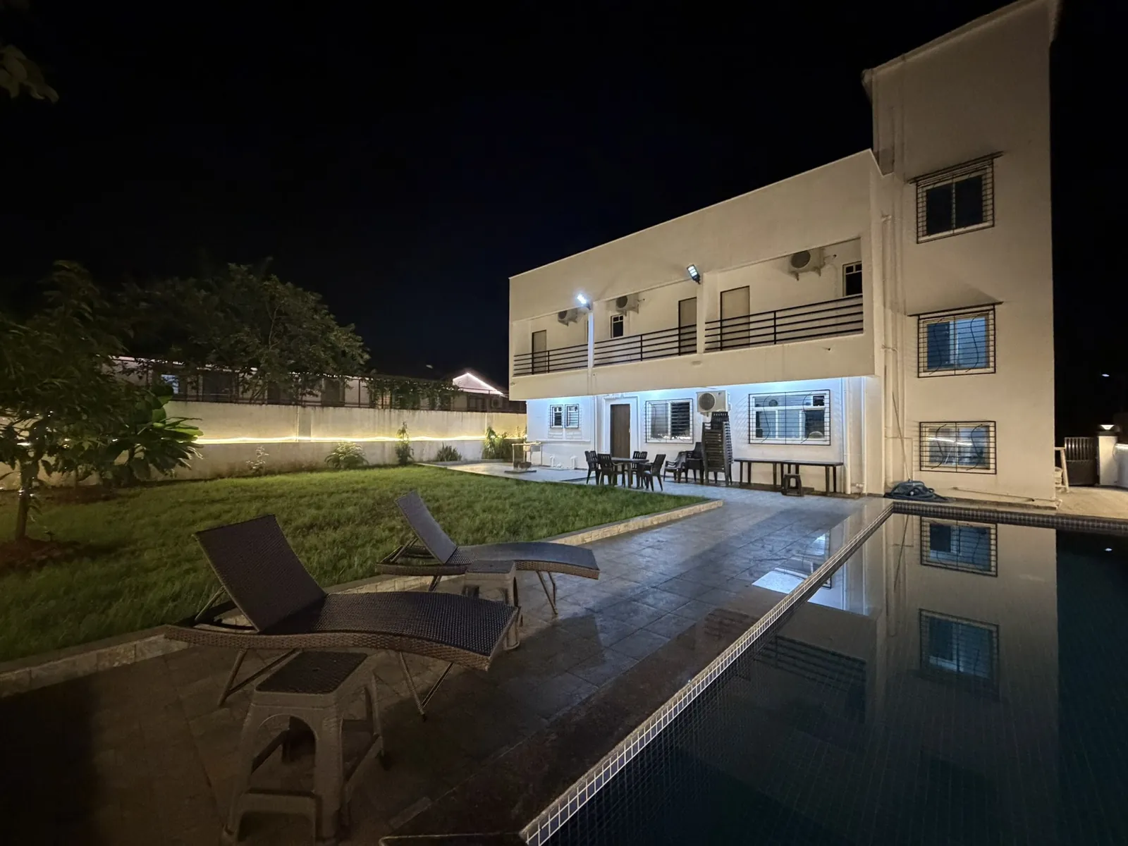 Nandan Villa in Karjat lit up at night beside its private pool