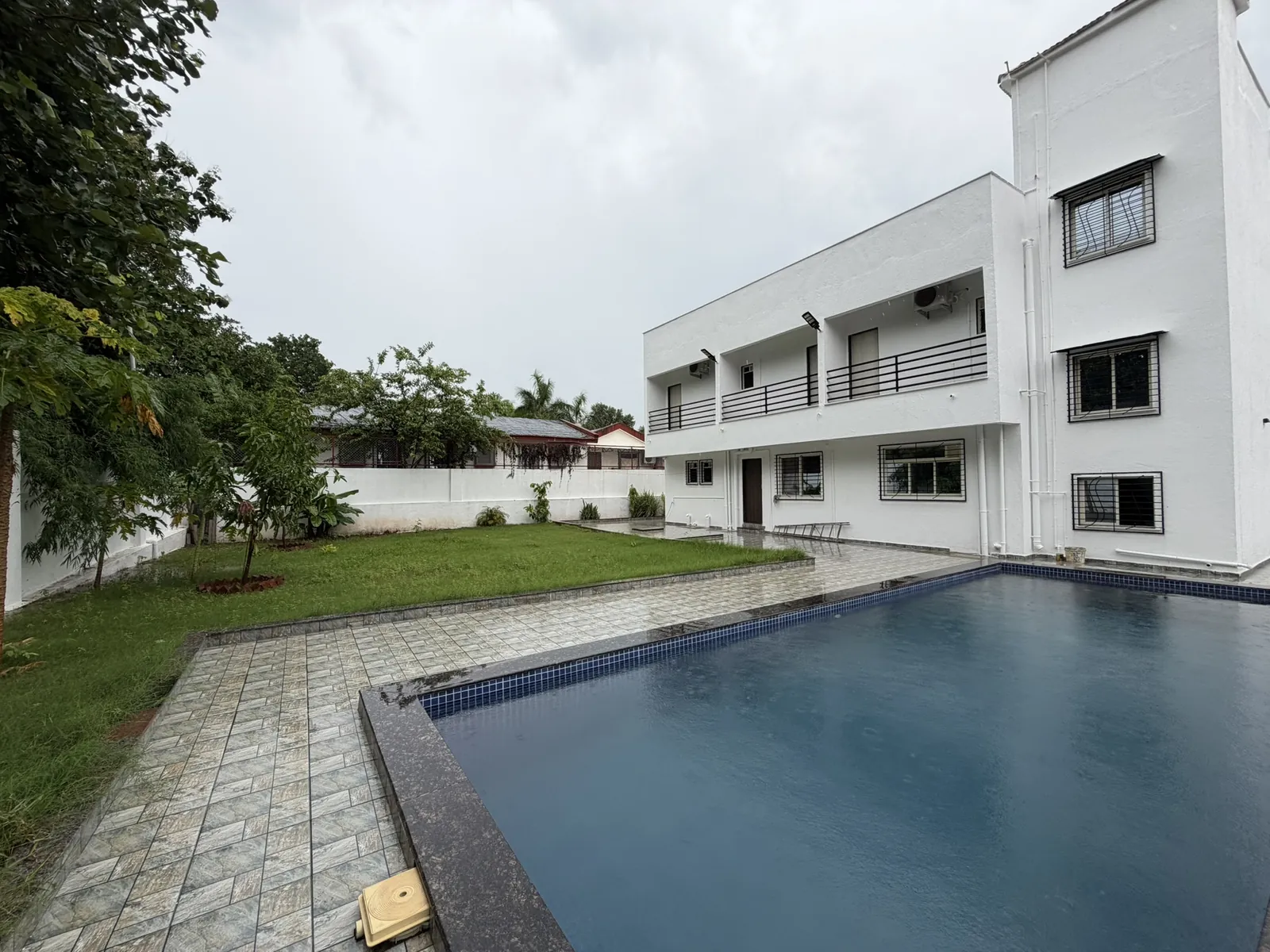 Nandan Villa, its private pool and lawn by day